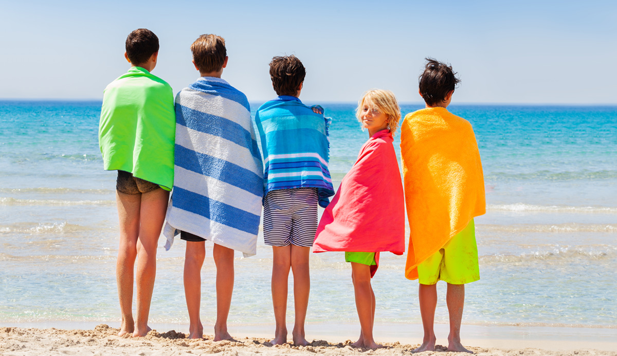 Boys,dry,off,with,beach,towel,after,sea,swimming